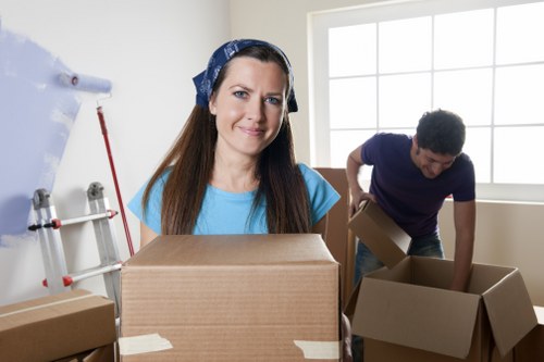 Movers packing fragile household items securely for transport