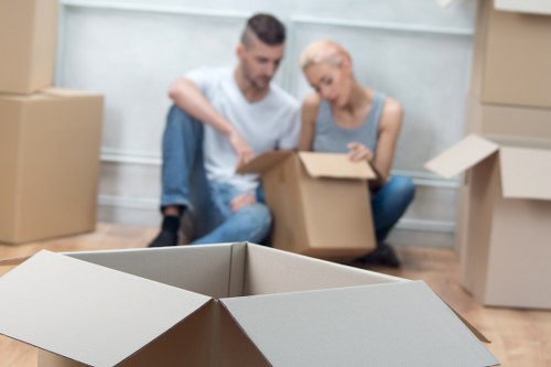 Movers carrying furniture through a residential property in Kingston