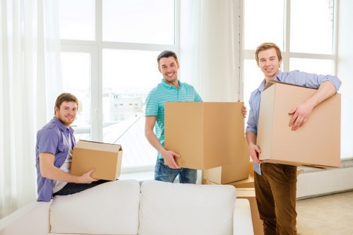 Professional movers handling office furniture and equipment